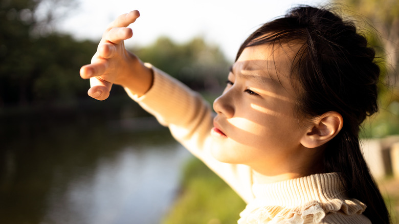 Woman shielding eyes from sun