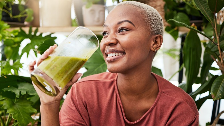 short-haired woman drinking a smoothie