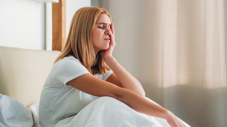 Woman sitting up in bed unable to sleep