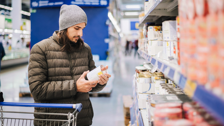 Man shopping for canned goods