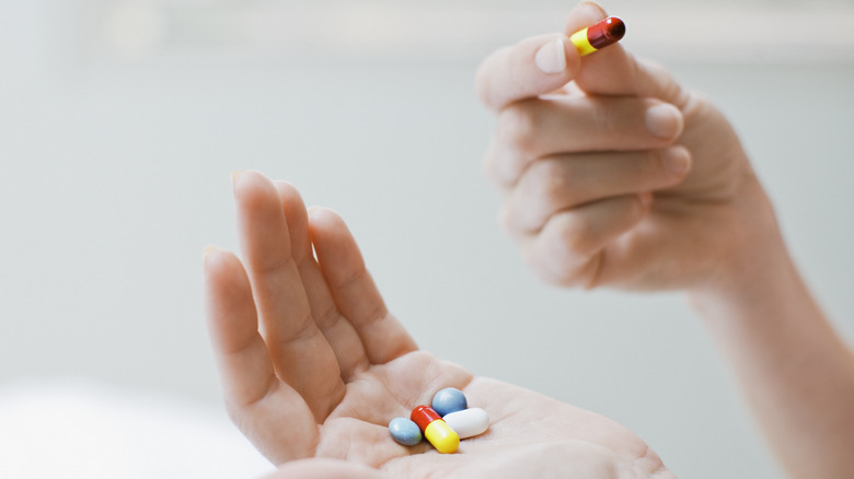 Pair of hands holding medications