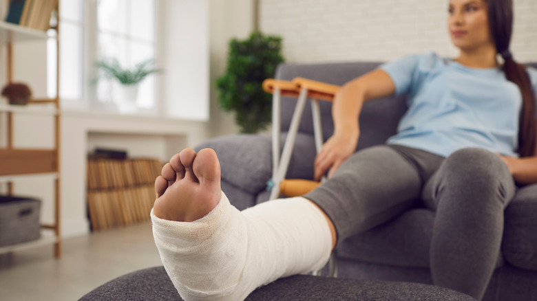 Seated woman with foot in cast