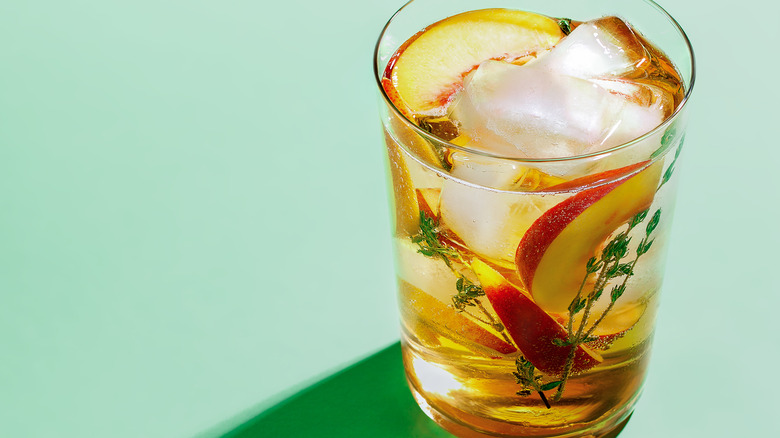 sparkling peach iced tea with sprigs of thyme 