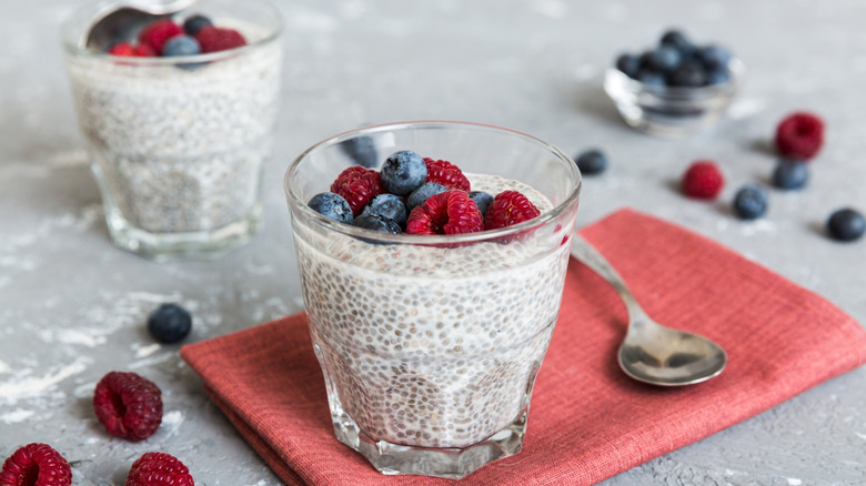 A glass of chia seed pudding topped with fresh berries