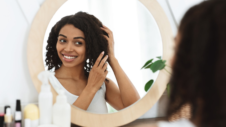 woman looking at hair 