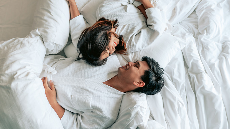 Couple laying in bed