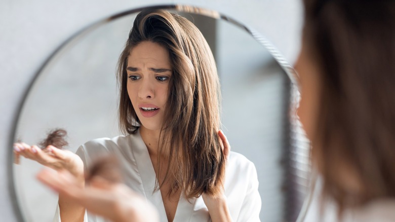 woman holding fallen hair