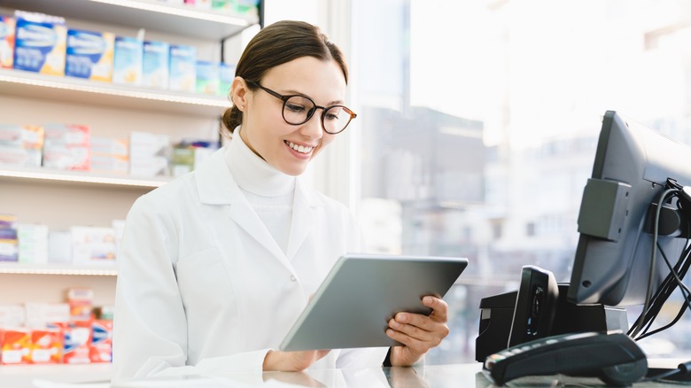 Pharmacist reading drug information