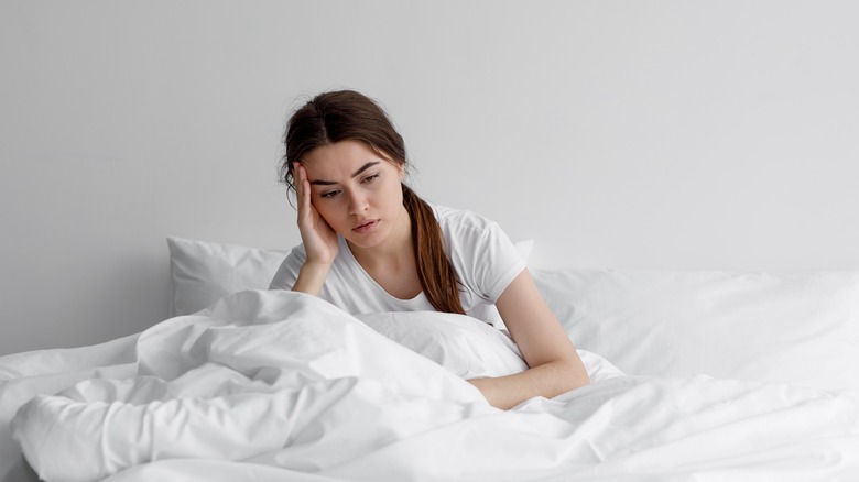 Woman sitting up in bed