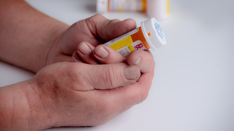 Person holding bottle of Tylenol