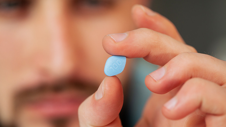 man holding viagra pills