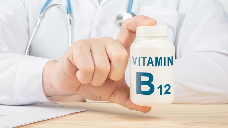 Doctor holding B12 supplements