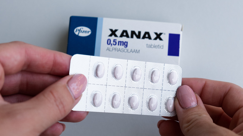 hands holding Xanax tablets