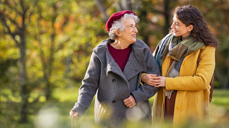 Old woman walking with younger woman 