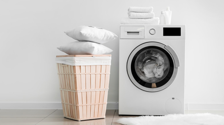 Washing machine with pillows next to it