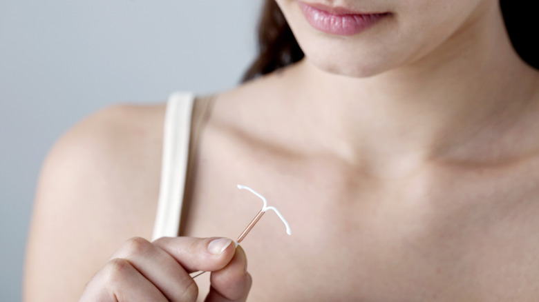 Woman holding copper IUD 