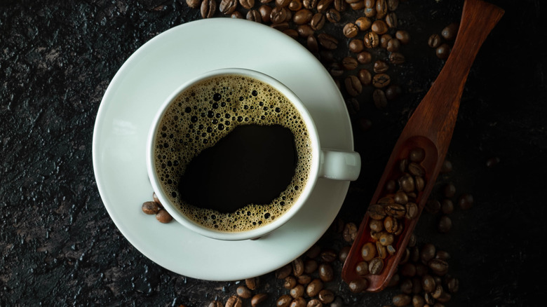 Cup of coffee with coffee beans 