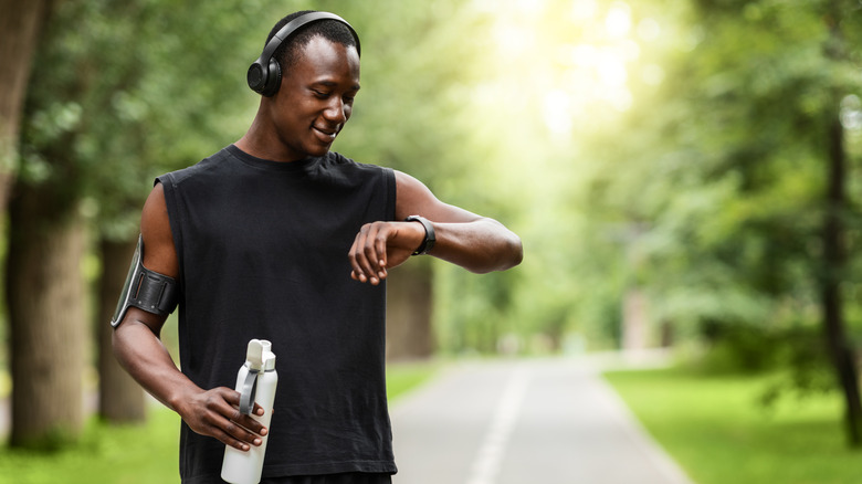 A man checks his smartwatch