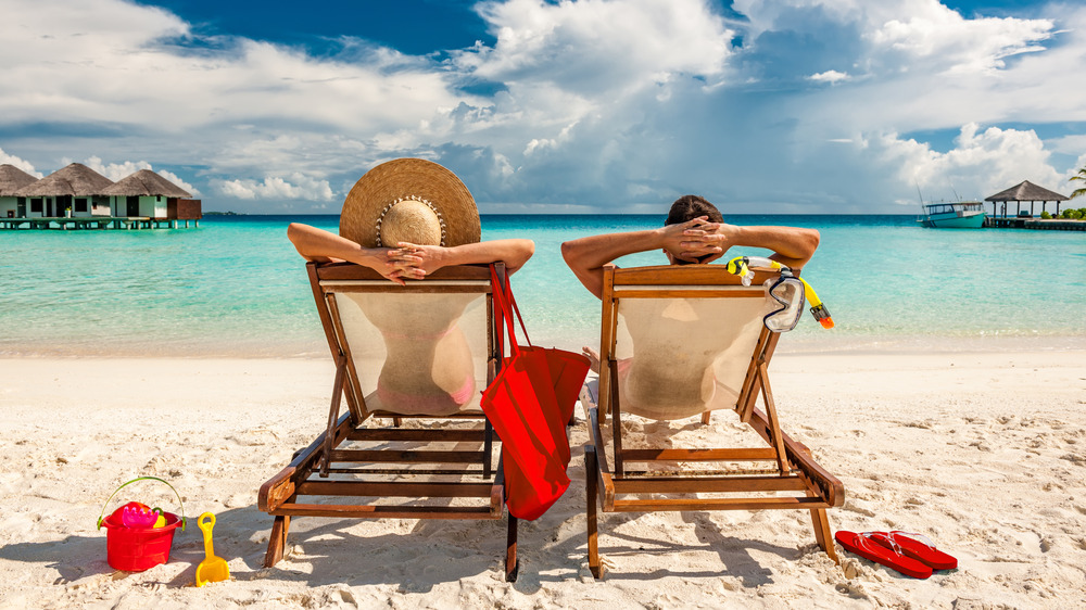 A couple sun tanning at the beach 