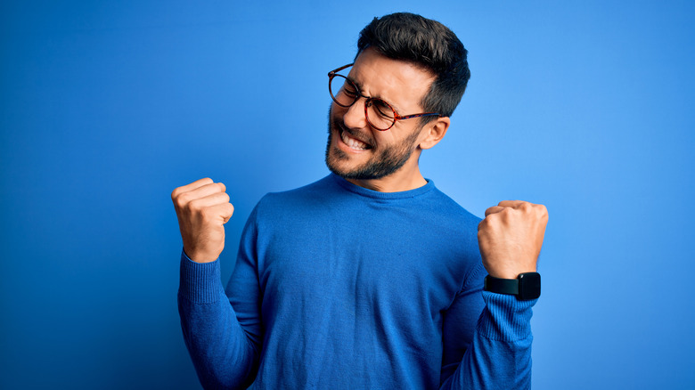 Bearded man smiling in victory