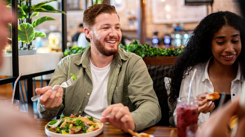 man eating a healthy dish of vegetables