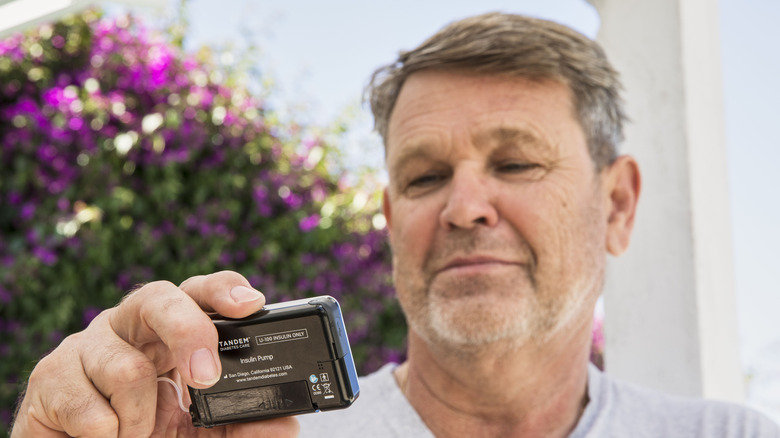 man checking his blood sugar levels