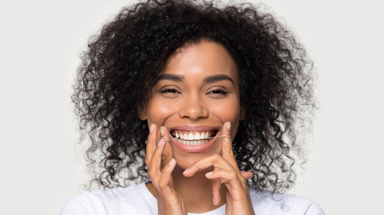 Woman flossing her teeth