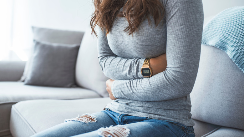 woman holding stomach