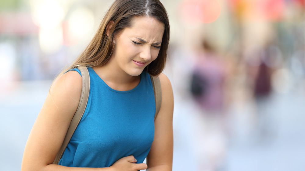 woman clutching her stomach