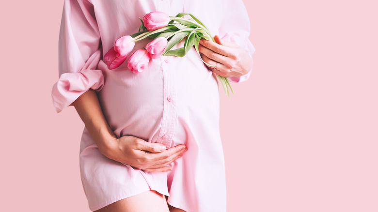 Pregnant woman holding flowers