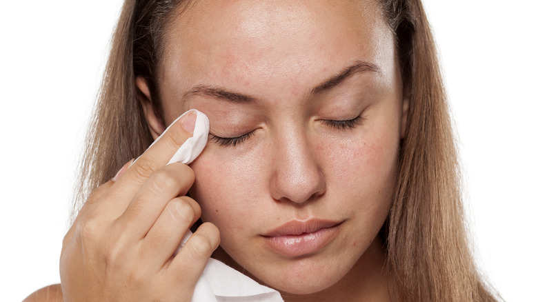 woman wiping eye