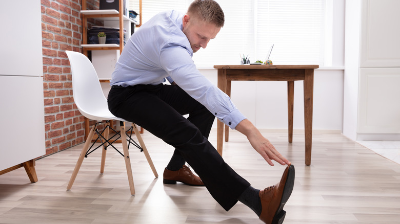 Man stretching and touching toes