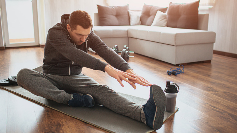 man stretching legs and arms