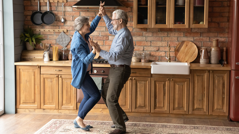 An older couple dancing in their kitchen