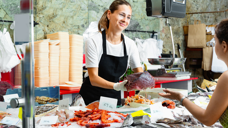 A woman works at a seafood counter