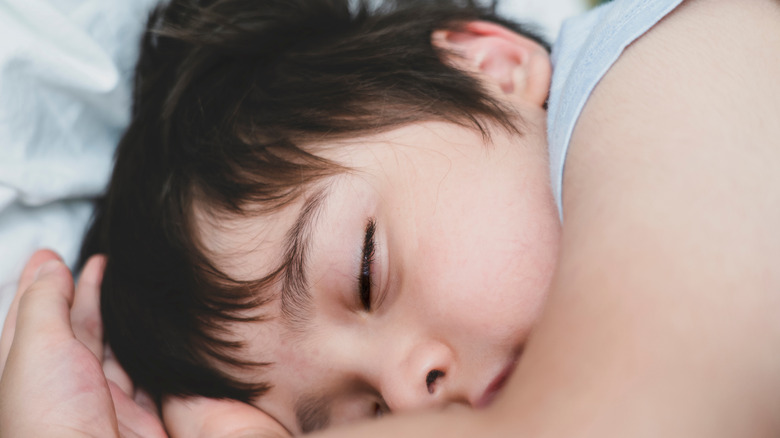 Child napping with one eye partially open