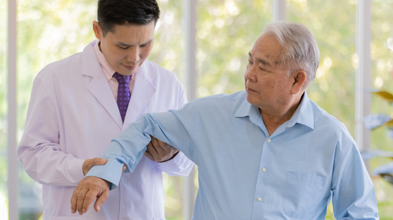 Doctor examining patient's arm