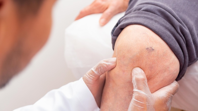 Doctor examining patient's leg