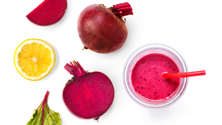 flat lay of beets, beet juice, and lemon