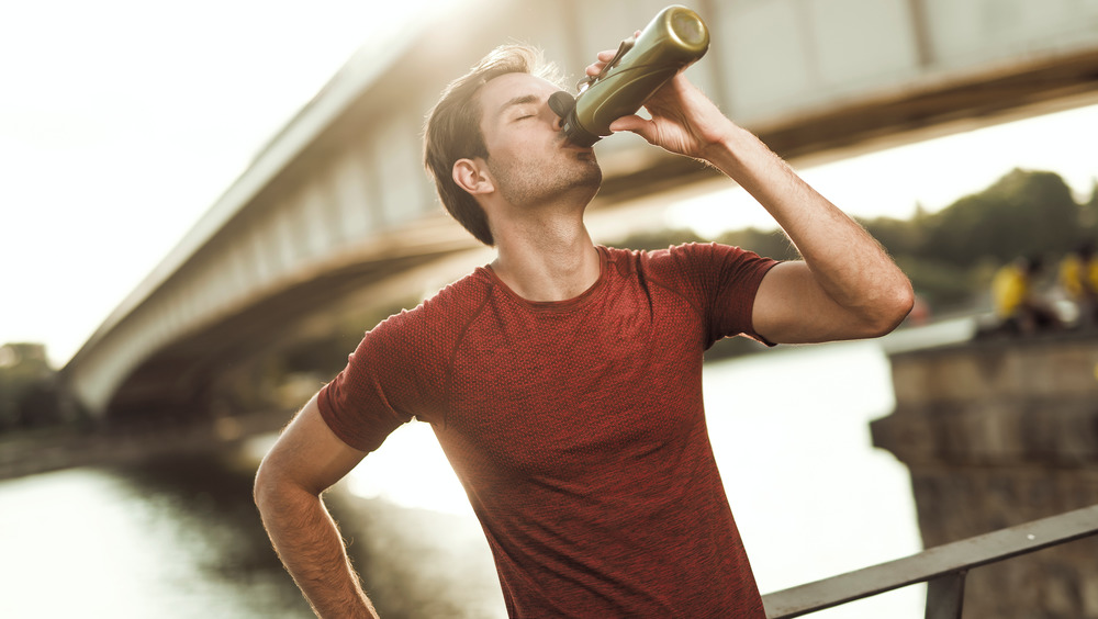 man drinking after workout