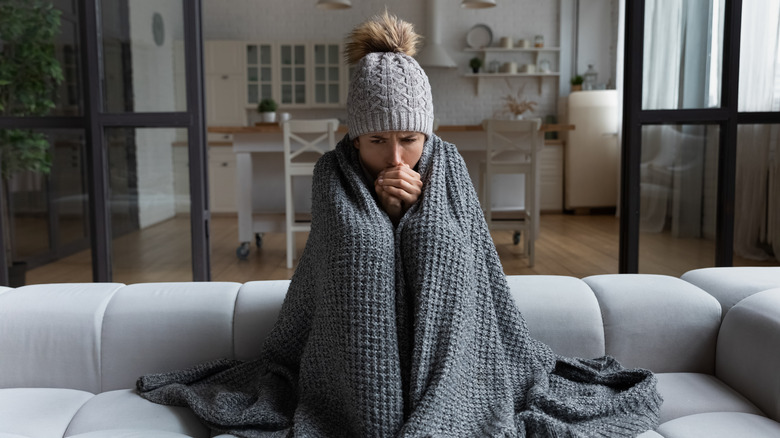 a woman bundled up inside 