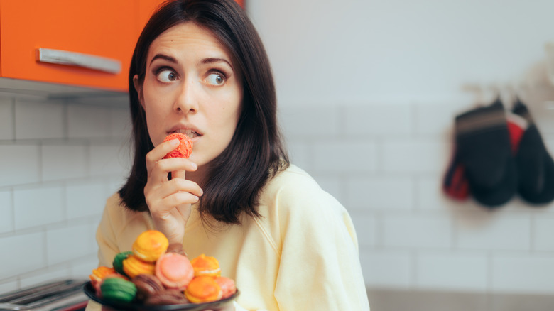 woman with full plate of macaroons