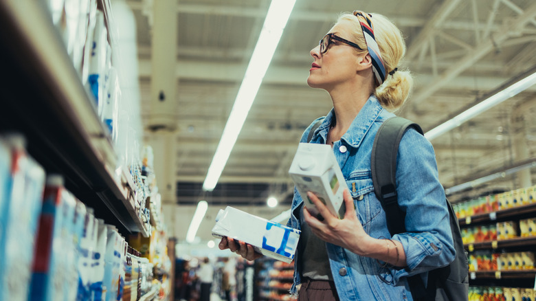 shopper comparing plant-based milk options