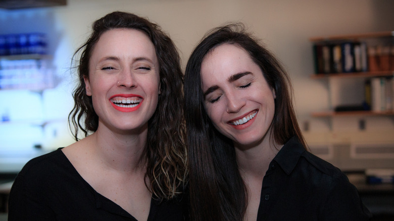 Erin Welsh and Erin Updyke of "This Podcast Will Kill You" in a lab laughing