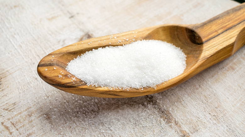 sucralose on a wooden spoon