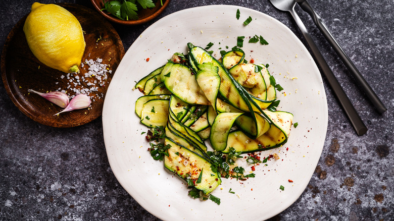 grilled zucchini strips and herbs on a plate