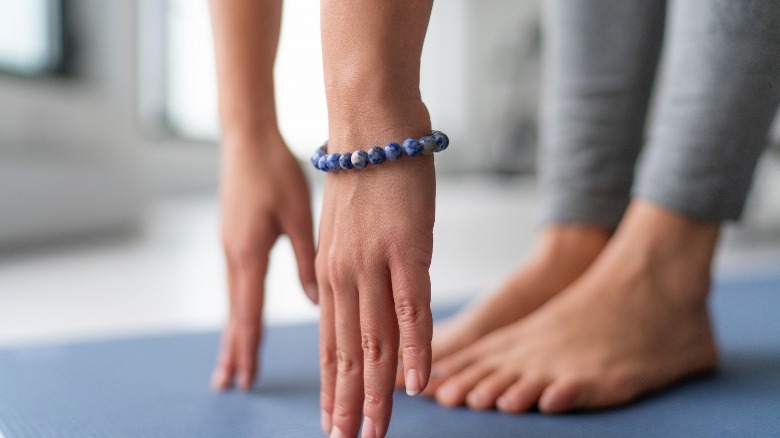 woman stretches hamstrings with toe touch