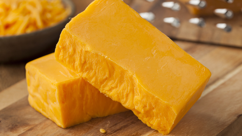 cubes of cheese on a cutting board