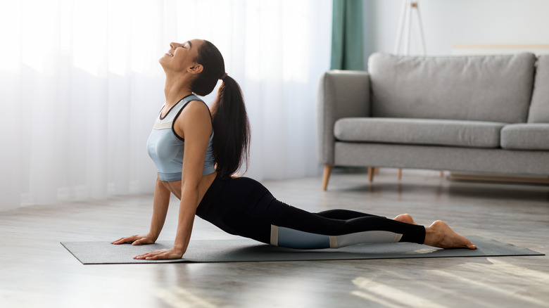 A woman does a yoga press up