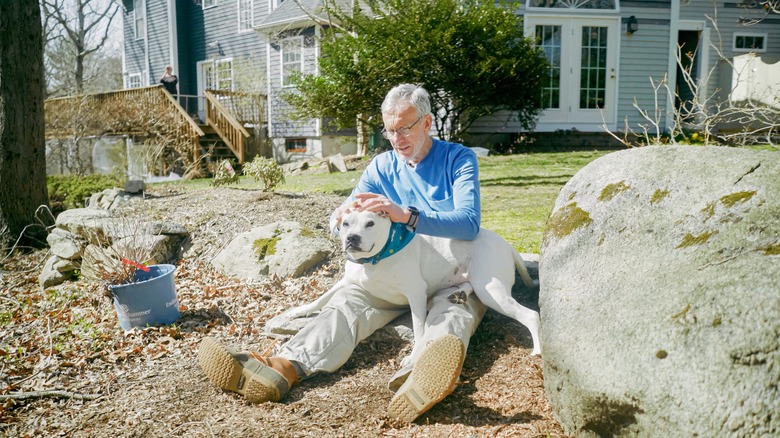 Dr. Thomas Mather performing a tick check on his dog